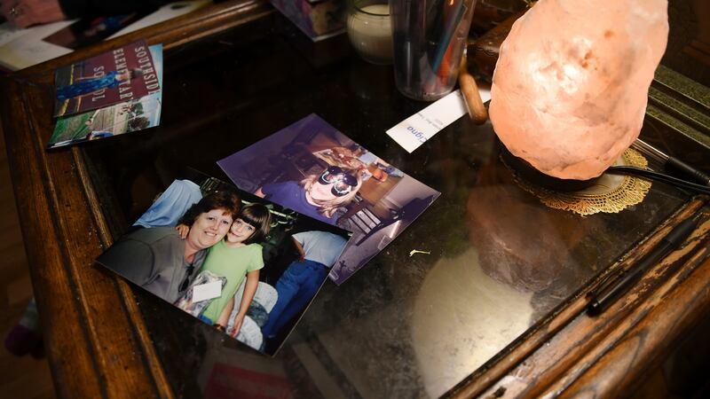 Childhood photos of Daniel Aston rest on a side table in his family's home in Colorado...