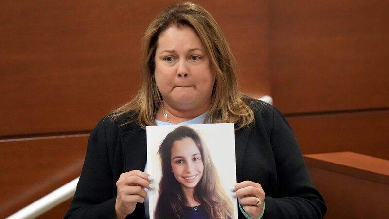 Jennifer Montalto holds a picture of her daughter, Gina, before giving her victim impact...