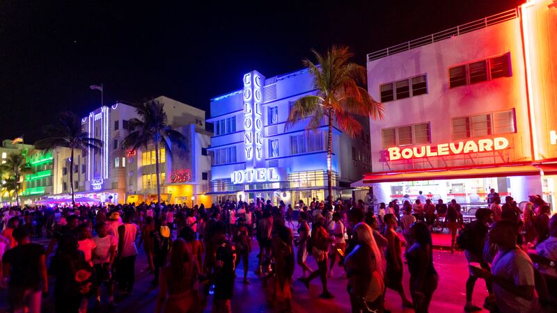 Crowds walk up and down Ocean Drive during spring break on Saturday, March 18, 2023, in Miami...