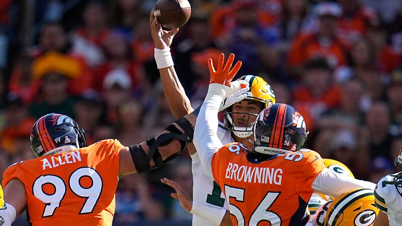 Green Bay Packers quarterback Jordan Love, middle, passes as Denver Broncos defensive end Zach...