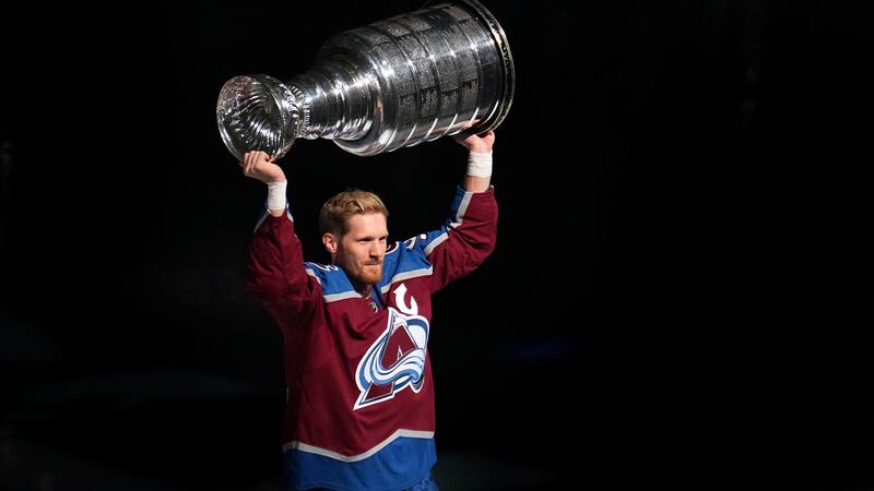 Colorado Avalanche left winger Gabriel Landeskog hoists the Stanley Cup for fans before the...