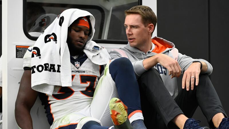 Denver Broncos running back Javonte Williams (33) is carted off the field during the second...