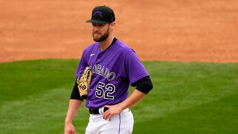 Colorado Rockies relief pitcher Daniel Bard (52) is pulled from the game with a bloodied hand...