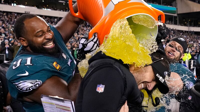 Philadelphia Eagles head coach Nick Sirianni, center, is doused by defensive tackle Fletcher...