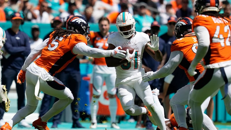 Denver Broncos linebacker Randy Gregory (5) attempts to stop Miami Dolphins running back...