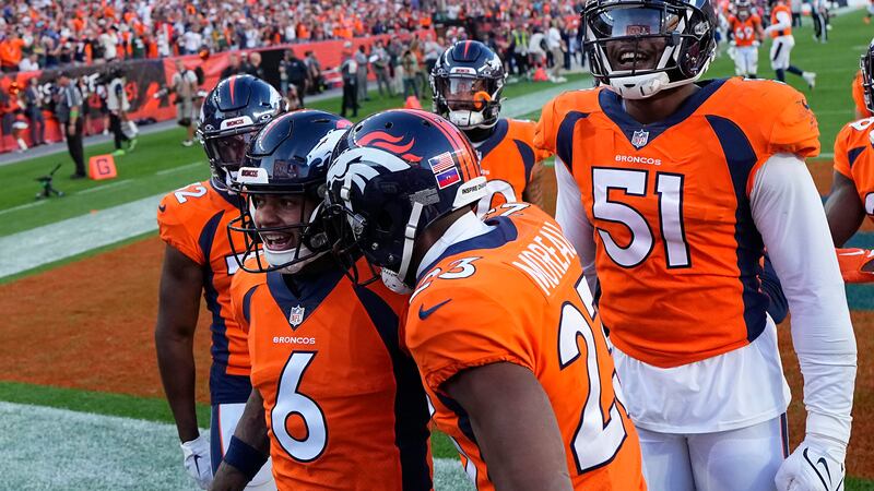 Denver Broncos safety P.J. Locke (6) is congratulated by teammates after intercepting a pass...