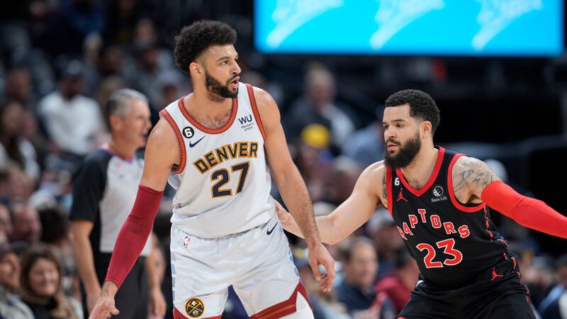 Denver Nuggets guard Jamal Murray, left, looks to pass the ball as Toronto Raptors guard Fred...