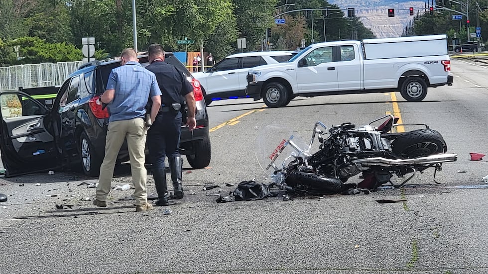Police comb over the scene of the accident on Patterson.